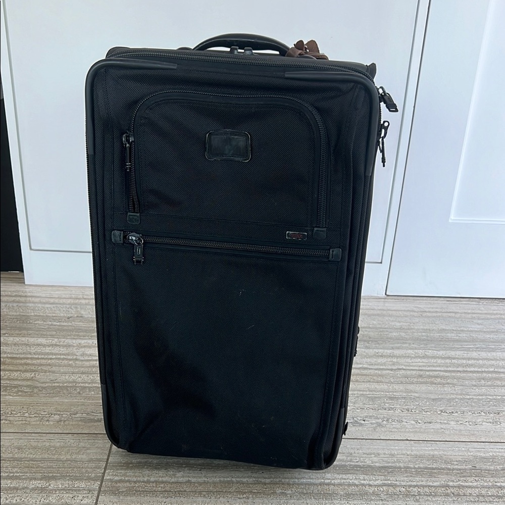 Tumi Black Upright Luggage with Durable Fabric and Retractable Handle